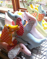 Load image into Gallery viewer, a group of simple sausage dog fabric toys
