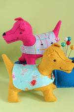 Load image into Gallery viewer, Two felt dogs wearing coats
