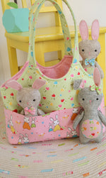 Load image into Gallery viewer, sewing pattern for small bag with outside pockets and felt bunnies.
