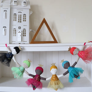 six dolls hanging in a garland