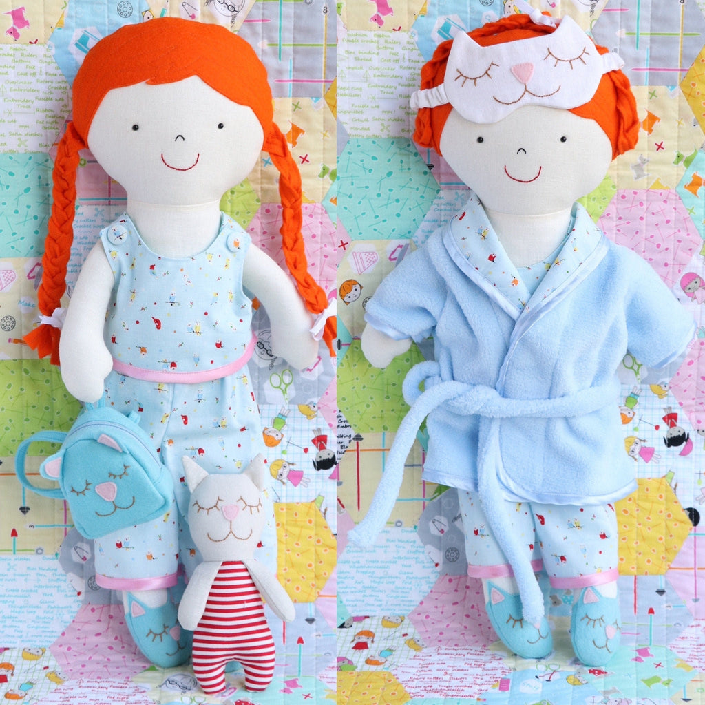 rag doll with red plaited hair wearing blue pyjamas and dressing gown. Doll has sleep mask, cat backpack and cat toy.