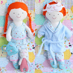 Load image into Gallery viewer, rag doll with red plaited hair wearing blue pyjamas and dressing gown. Doll has sleep mask, cat backpack and cat toy.
