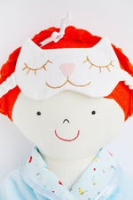 Load image into Gallery viewer, close up of cloth doll face with kitty sleep mask resting on her head.
