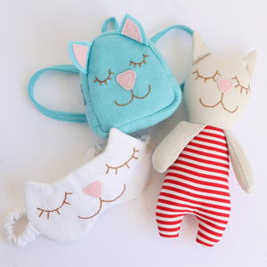 close up of sewing pattern items for sleep mask, cat backpack and cat shaped toy